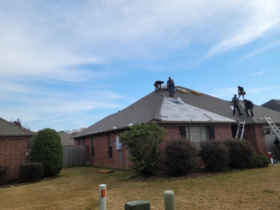 men replacing roof after hail storm in arkansas